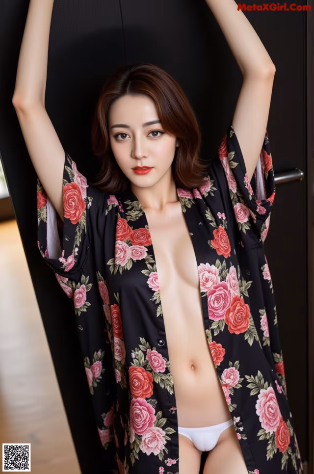 A woman in a black and pink floral robe posing for the camera.