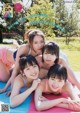 A group of young women laying on top of a yoga mat.