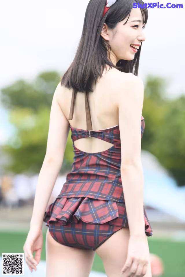 A woman in a red and black plaid bathing suit.